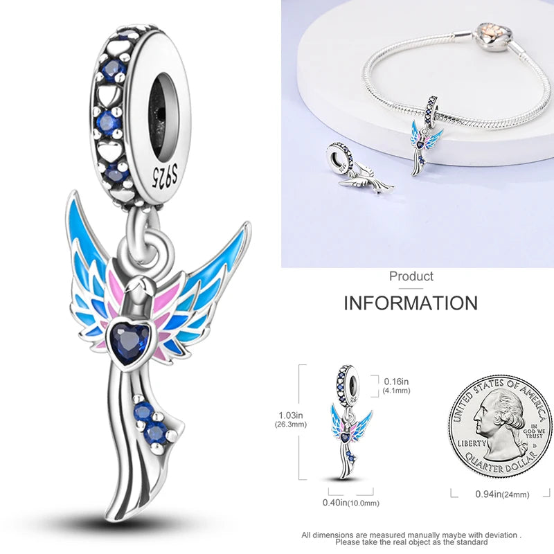 925 sterling silver angel-wing charm with blue enamel and dark heart-shaped stone