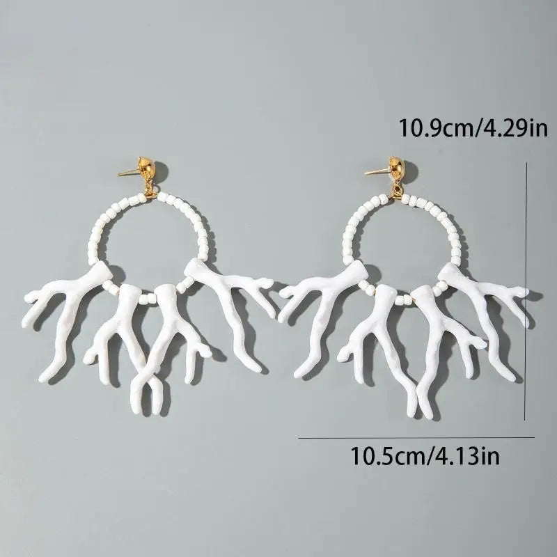 White acrylic drop earrings with round bead hoops and coral-like fringe drops