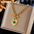 Gold-tone heart pendant necklace with green square stone heart charm and curb chain
