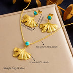 Gold-tone jewelry set in box: turquoise ginkgo leaf pendant necklace and matching earrings