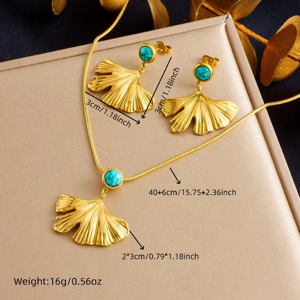 Gold-tone jewelry set in box: turquoise ginkgo leaf pendant necklace and matching earrings