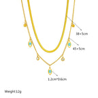 Gold-tone double-layer snake chain necklace with blue evil-eye charms; length 38+5cm & 45+5cm