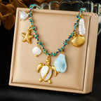 Sea turtle and starfish pendant necklace with mixed pearls and shells, blue beads