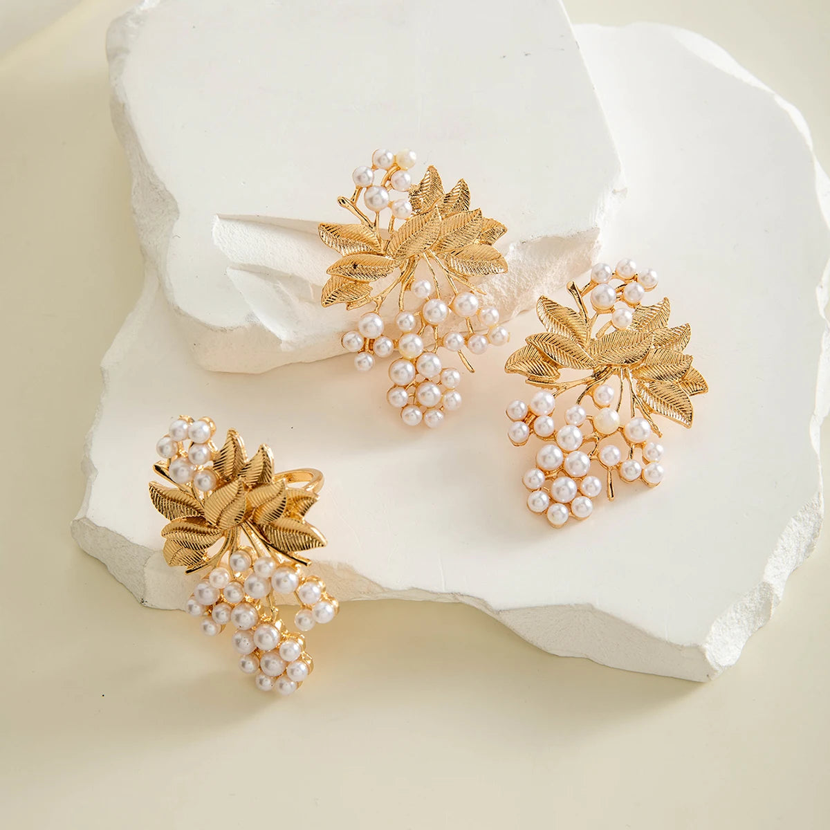 Gold-tone leaf and pearl cluster drop earrings with pearl top detail