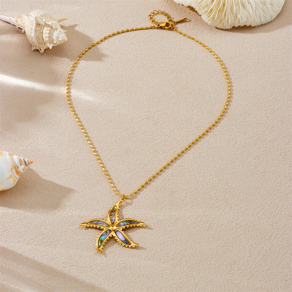 Gold-tone starfish flower pendant necklace with blue enamel charm