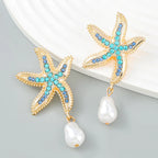 Gold-tone starfish earrings with blue/turquoise crystals and white pearl drop pendants