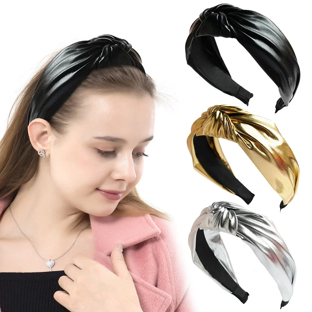 Black PU leather wide headband with twisted knot; gold and silver shown