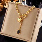 Gold-tone heart and black-stone pendant necklace with heart charm and round drop