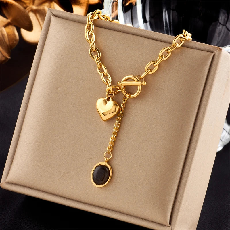Gold-tone heart and black-stone pendant necklace with heart charm and round drop