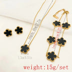 Gold-tone clover jewelry set with black enamel necklace, bracelet, and stud earrings