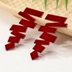Geometric stud earrings in glossy red with jagged zigzag blocks and pointed details
