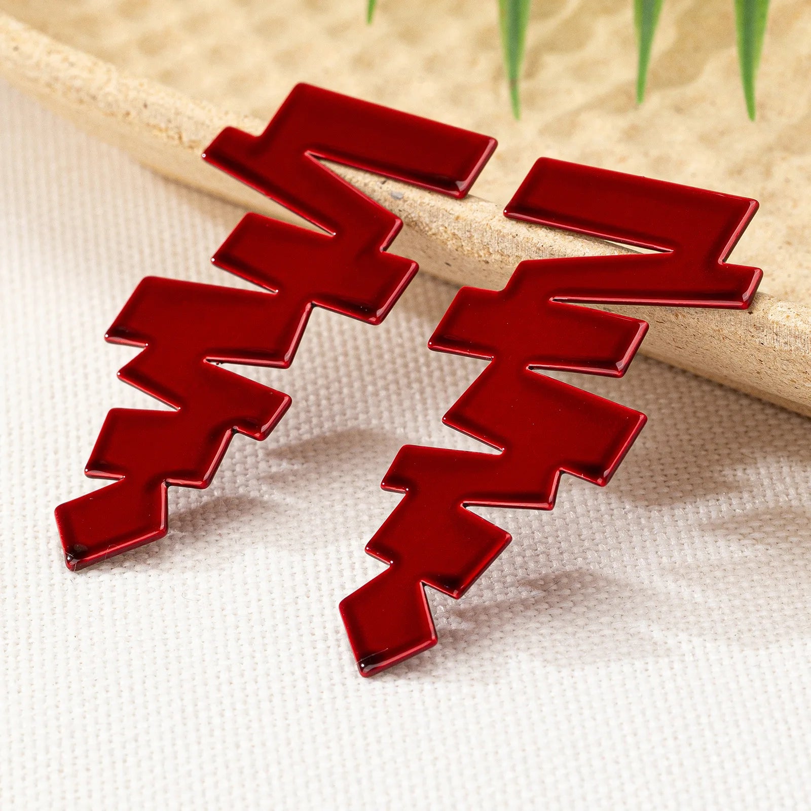 Geometric stud earrings in glossy red with jagged zigzag blocks and pointed details