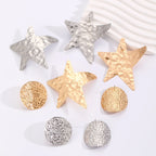 Assorted metal earrings with star and round stud shapes in gold and silver