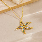 Starfish flower pendant necklace with gold-tone chain and blue enamel starfish