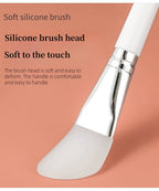 Silicone face mask brush with curved white silicone head and white handle