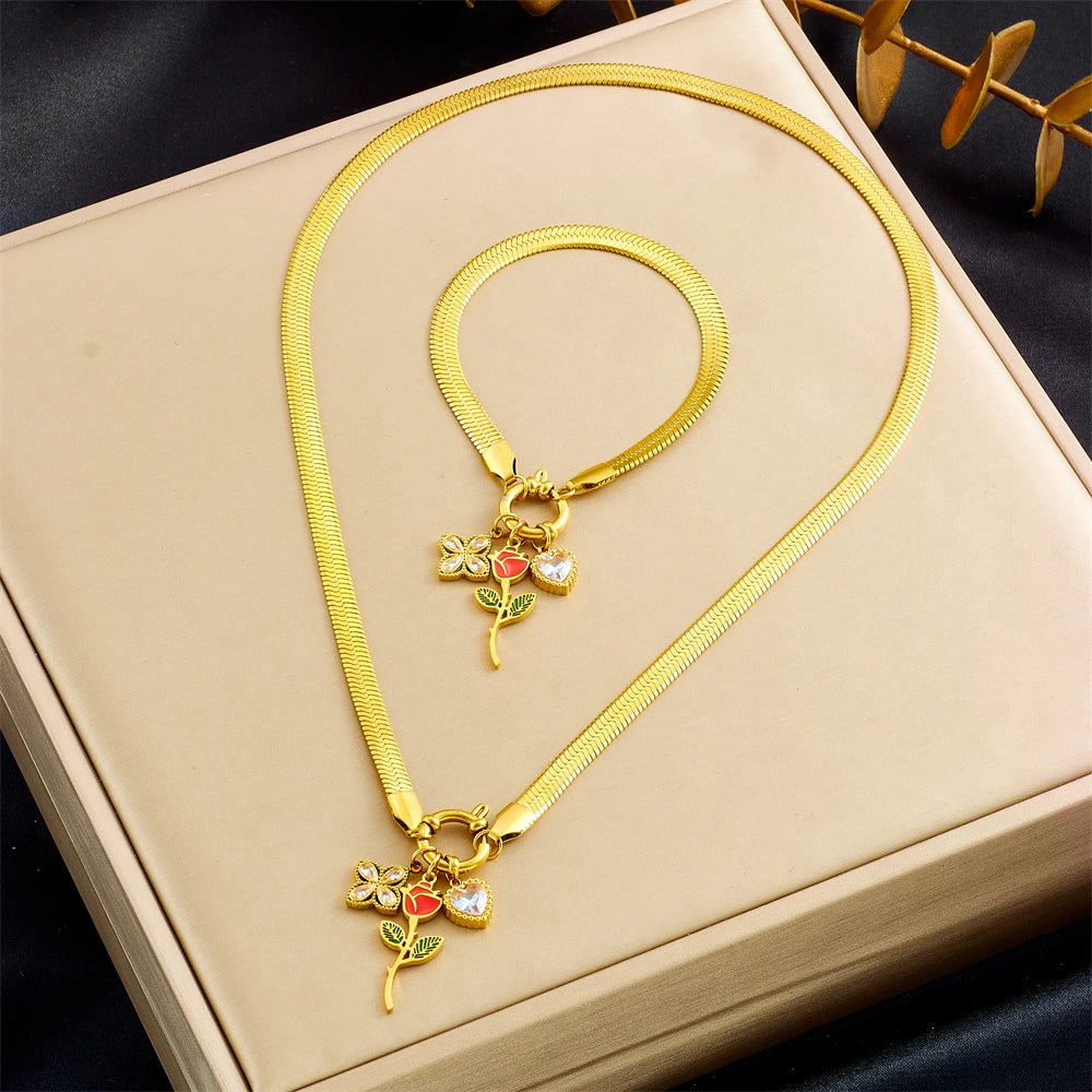 Gold-tone rose pendant necklace set and bracelet with red enamel flower, green leaves