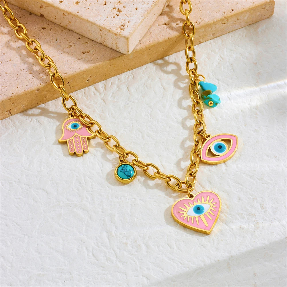 Gold-tone charm bracelet with evil eye, hamsa hand, and turquoise heart charms