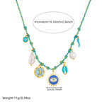 Turquoise beaded pendant necklace with sun-eye charm, moon disc, and pearl tear drop