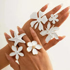 White flower adjustable ring with five white petals and gold-tone center