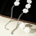 White flower earrings with silver-tone hooks and matching necklace chain