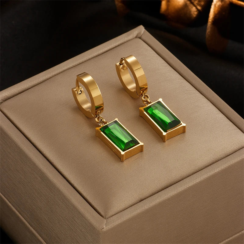 Gold hoop earrings with green square-stone dangle charms