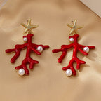 Pair of coral starfish earrings with red enamel, gold-tone starfish, and pearl-like beads