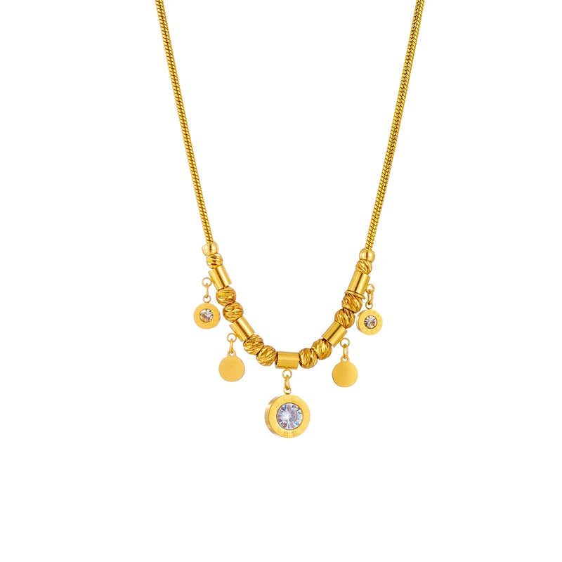 Gold-tone charm necklace with circular zircon pendant and dangling coin charms