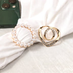 Pearl circle scarf brooch clip and heart-shaped rhinestone brooch clip on white fabric