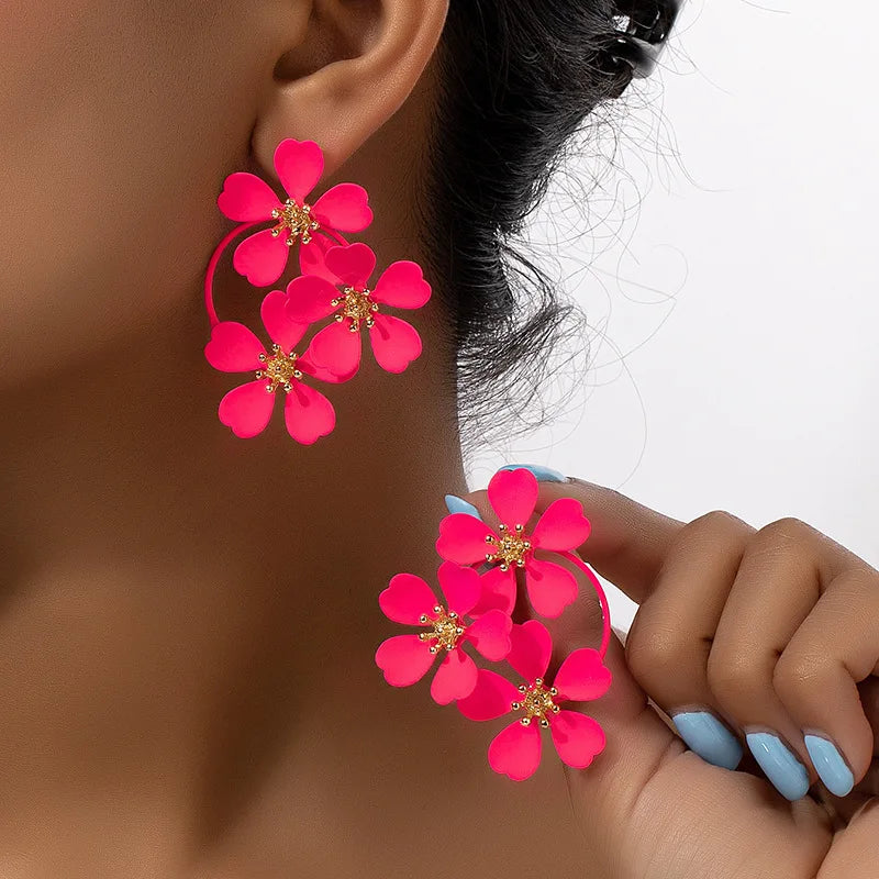 Flower dangle earrings with bright pink five-petal flowers and gold-tone hoop loops
