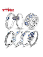 Sterling silver evil eye ring assortment with blue eye accents and filigree band cutouts