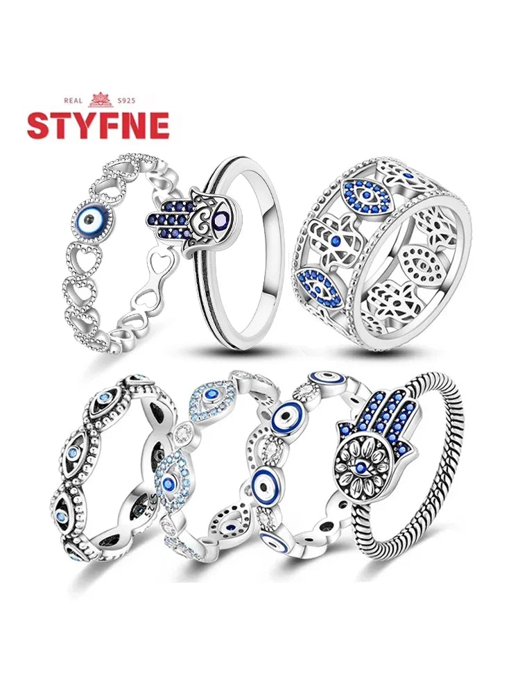 Sterling silver evil eye ring assortment with blue eye accents and filigree band cutouts