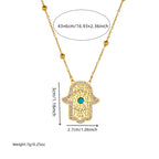 Gold-tone hamsa pendant necklace with turquoise stone and bead chain