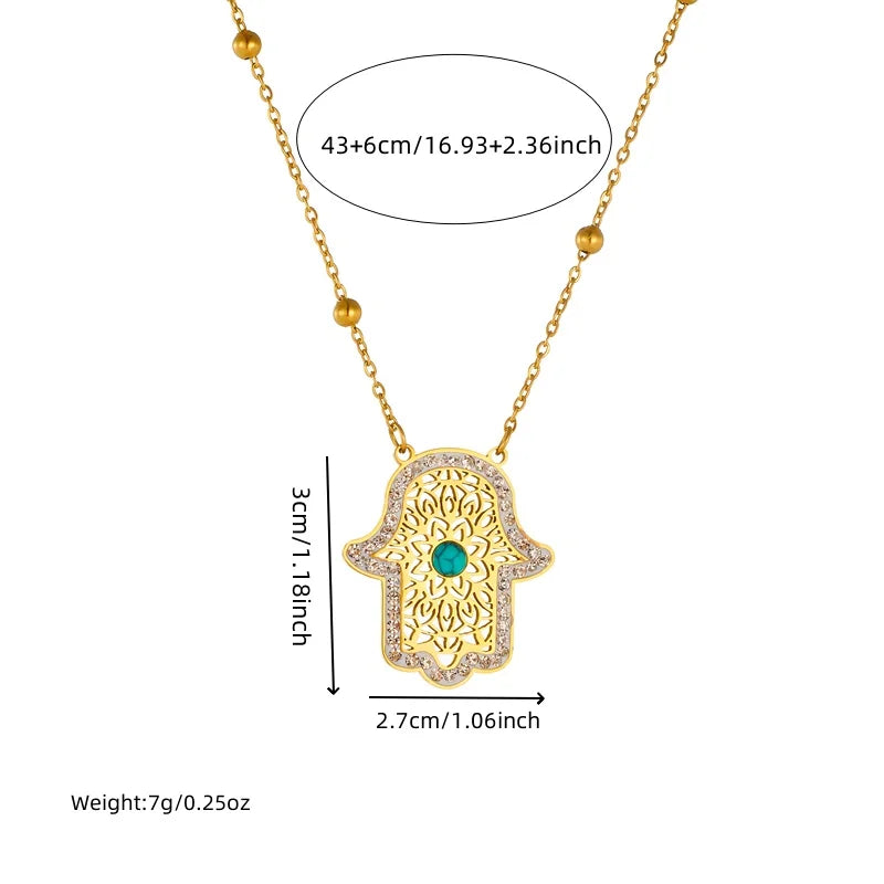 Gold-tone hamsa pendant necklace with turquoise stone and bead chain