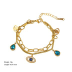 Gold-tone evil-eye double bangle bracelet with blue drop and eye charms