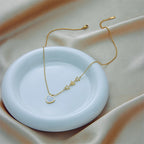 Gold-tone heart and star pendant necklace with small heart charm
