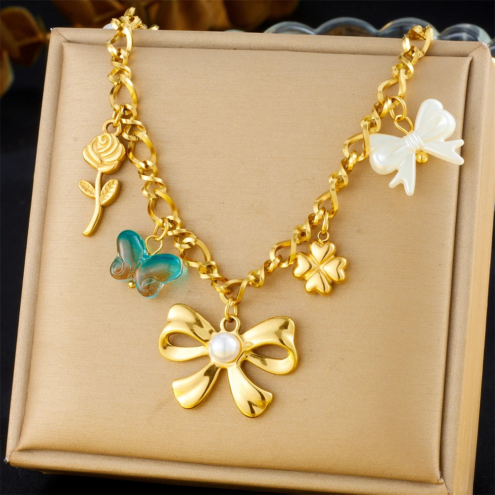 Gold-tone heart and flower multi-pendant necklace with turquoise enamel accents