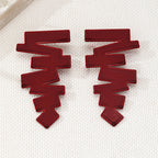 Geometric stud earrings in red with flat, layered zigzag blocks and pointed ends