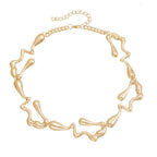 Gold-tone lava-drop choker necklace with abstract sculpted link design