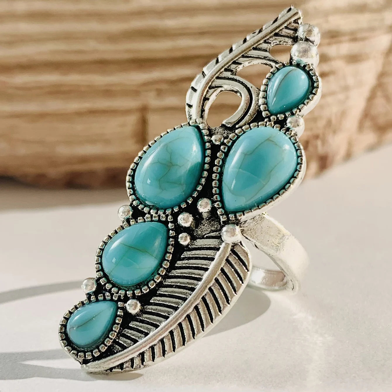 Turquoise cabochon statement boho ring with scalloped bezels and feather band
