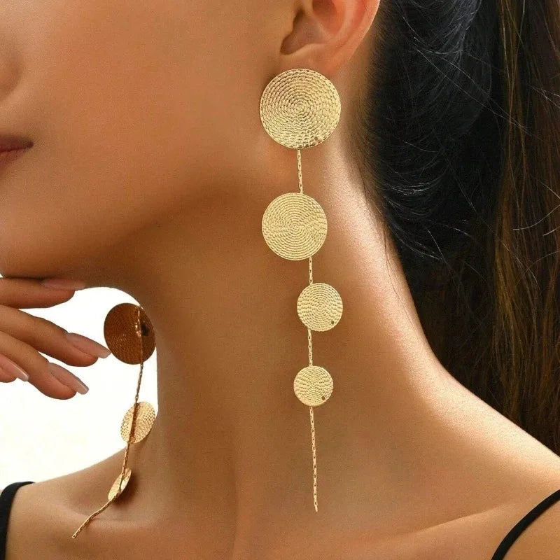 Gold-tone woven disc dangle earrings with four hanging circles and long tassel drops