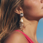 Striped black-and-white fishbone dangle earrings with gold-tone skeleton drop
