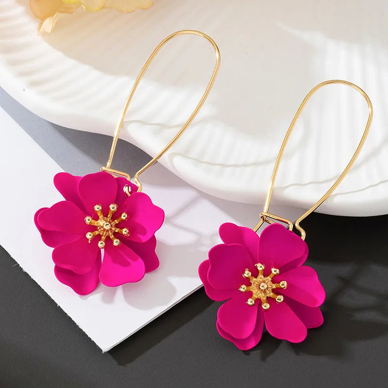 Floral stud earrings with layered hot-pink flower petals and gold-tone hooks