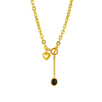 Heart pendant necklace with gold-tone chain and round black stone drop