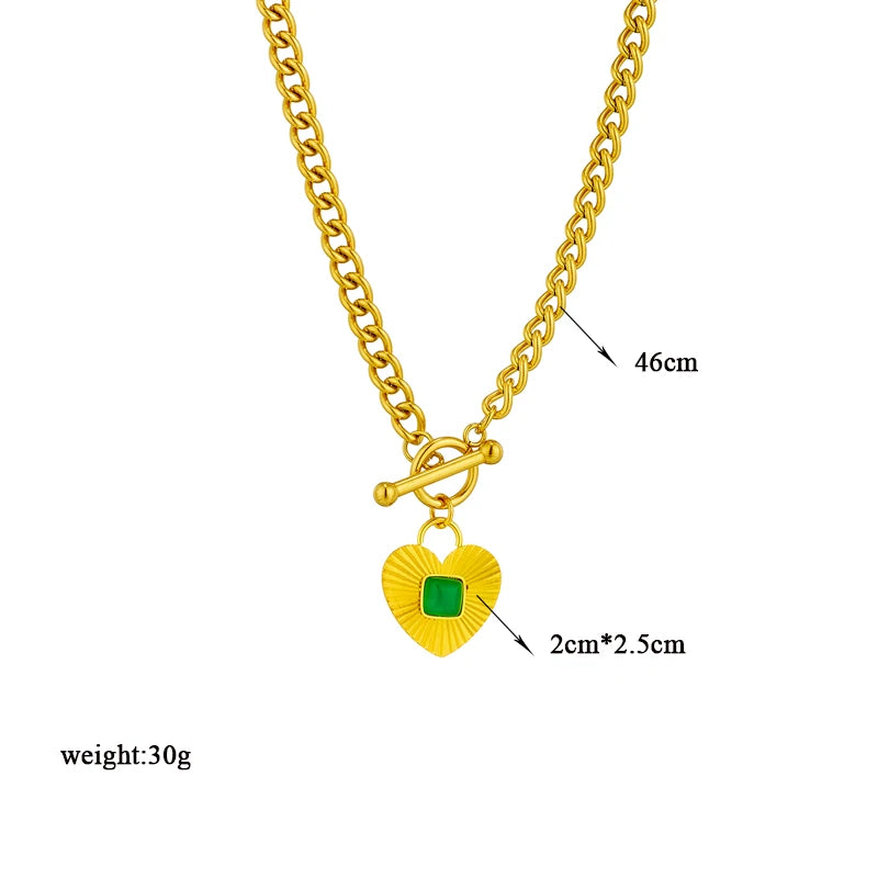 Gold-tone chain necklace featuring a green square stone heart charm and toggle clasp