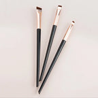 Eyeliner and eyebrow makeup brushes, three slim handles with angled copper bristles