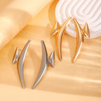 Spiked hoop earrings in gold and silver, elongated teardrop spike shapes