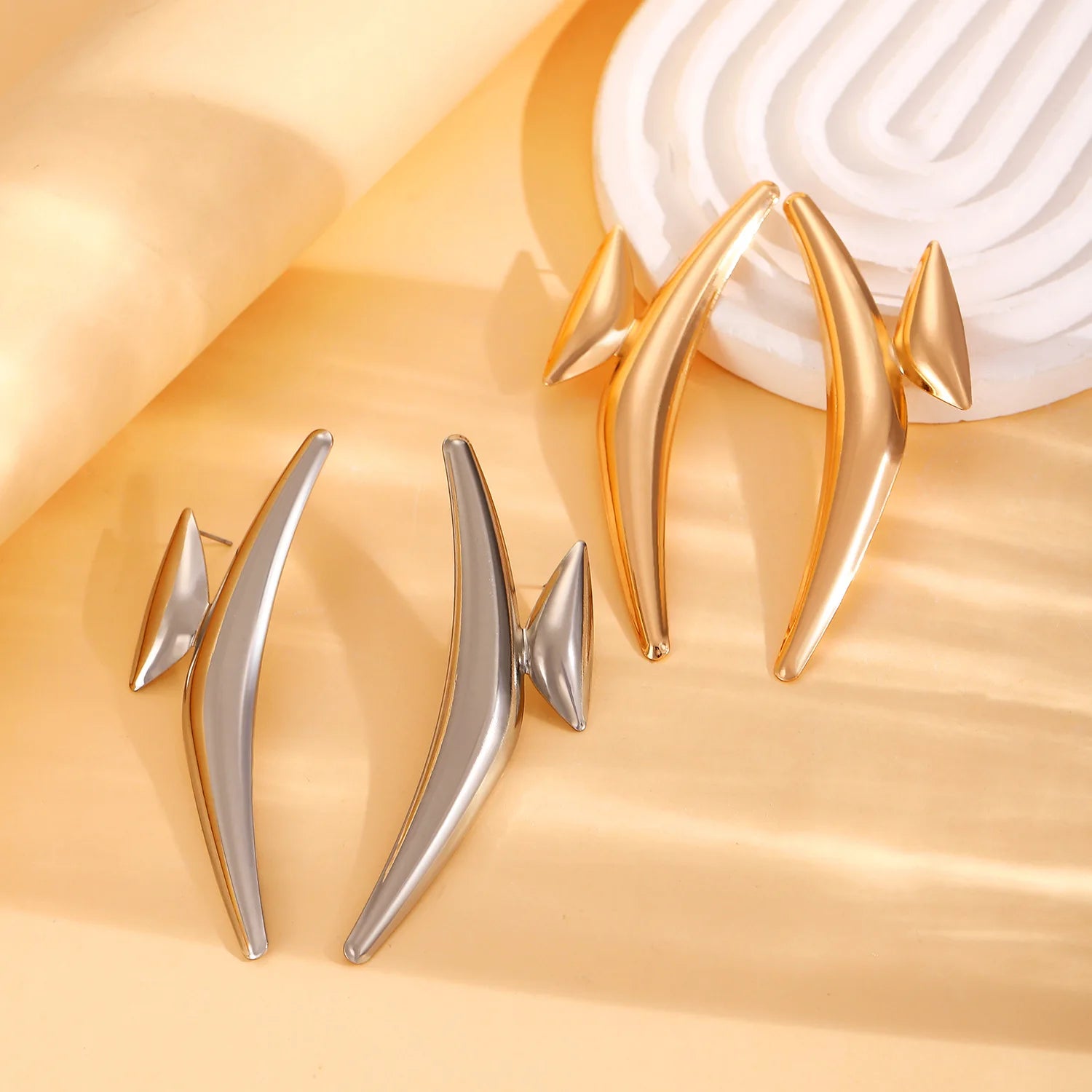 Spiked hoop earrings in gold and silver, elongated teardrop spike shapes