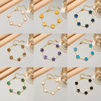 Gold flower bracelet set with enamel clover charms in pink, yellow, and blue