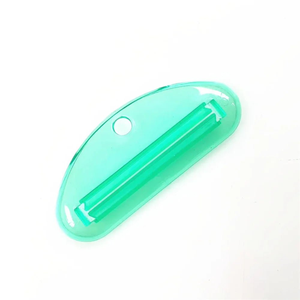 Green toothpaste tube squeezer dispenser with slotted metal insert and hanging hole
