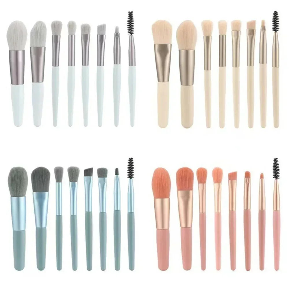Makeup brush assortment with gray, beige, and gold handles; includes mascara spoolie